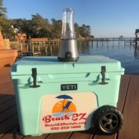 A Yeti Cooler with Blender and ICE, with a light on it sitting on a dock, available for OBX Beach Equipment Rentals.